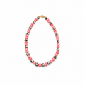 A beaded necklace featuring alternating pink and black-and-white spotted beads, completed with a gold clasp, shown on a plain white background.
